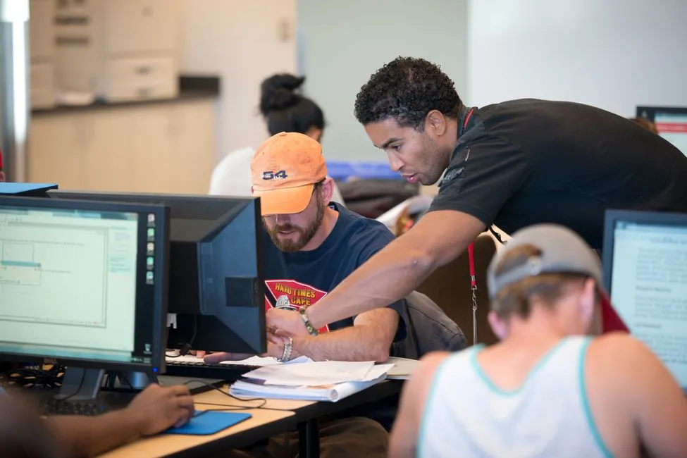 Science Center Tutor working with a student on the computer